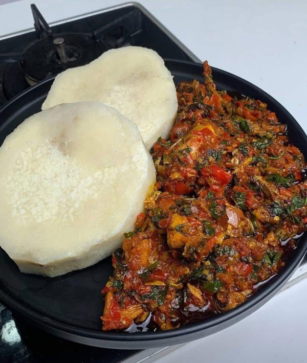 Boiled yam served with vegetable sauce and meat