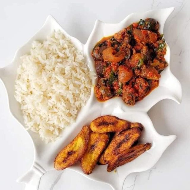 White rice and stew served with plantain